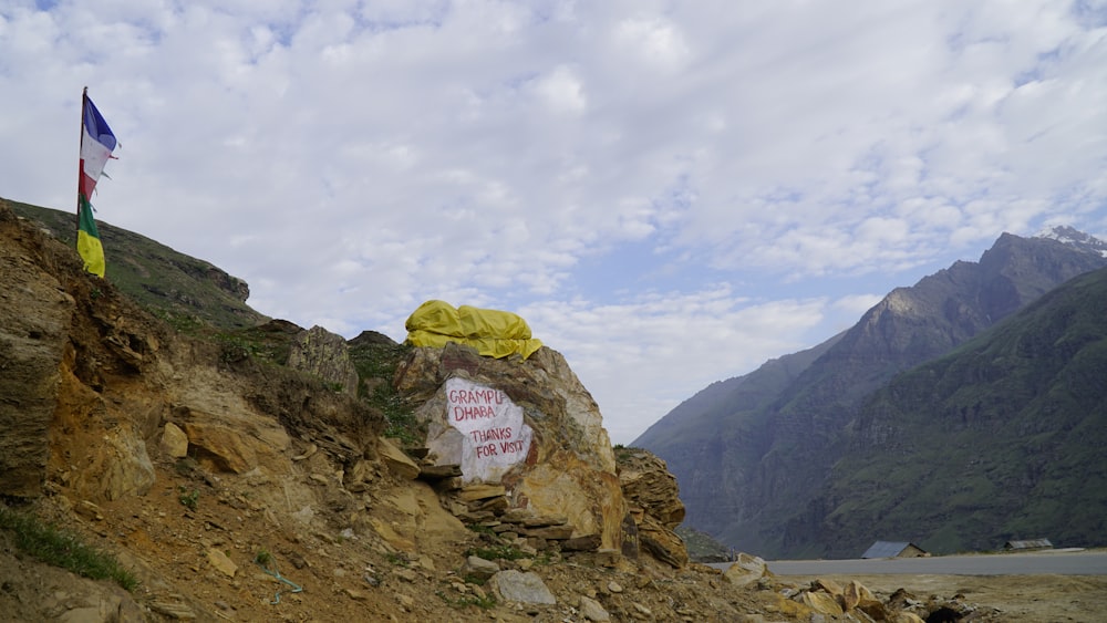 a sign that is on the side of a mountain