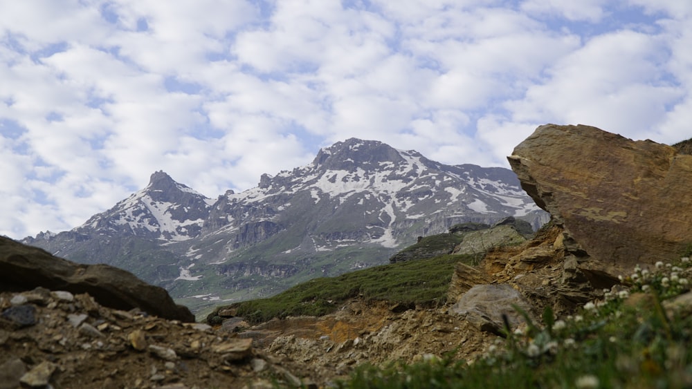 a view of a mountain range with rocks and grass