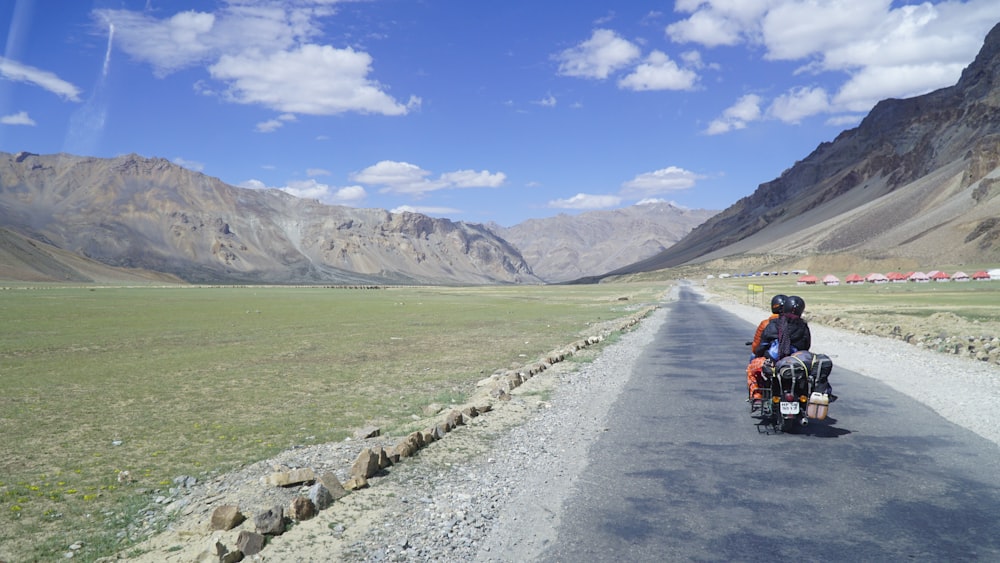 a person riding a motorcycle down a road