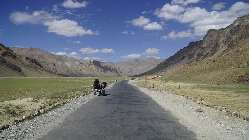 a person riding a motorcycle down a road