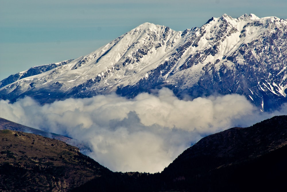 a view of a mountain range covered in clouds