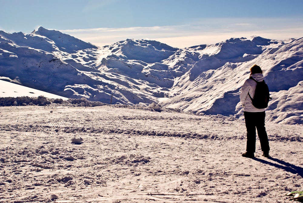 a person standing on top of a snow covered slope