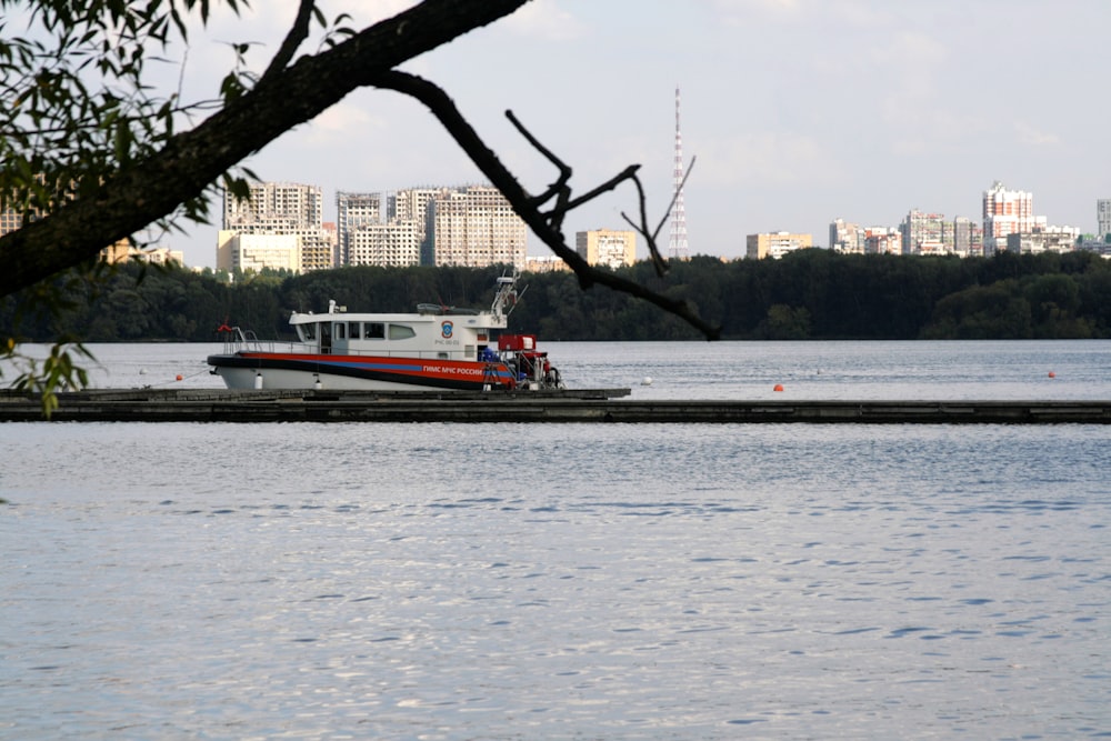 a red and white boat on a body of water