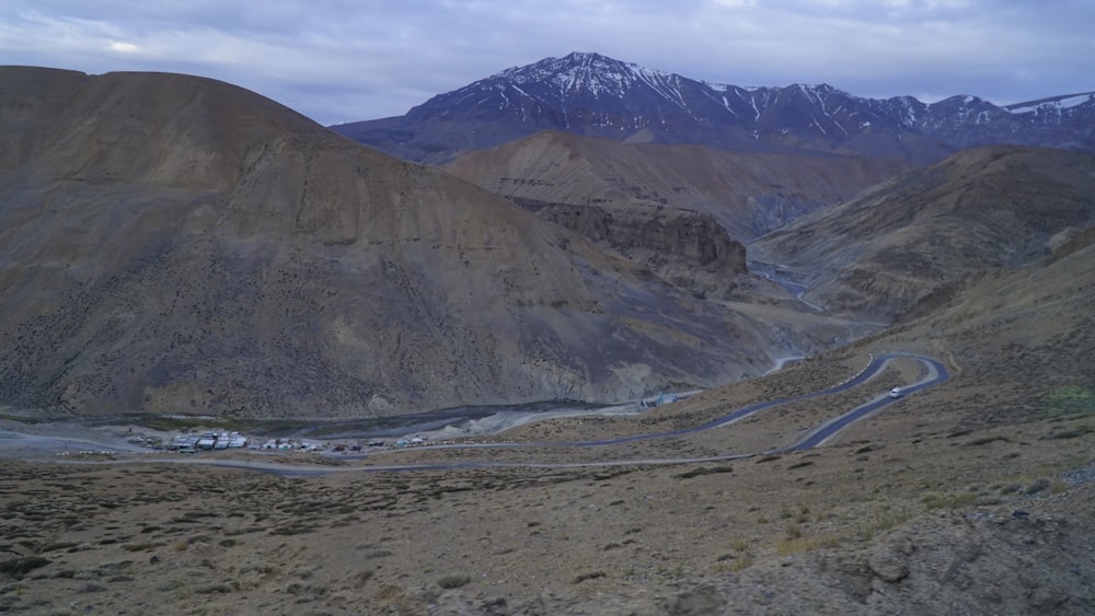 a winding road in the middle of a mountain range