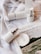 A serene flat lay of various skincare products arranged on a wooden surface.