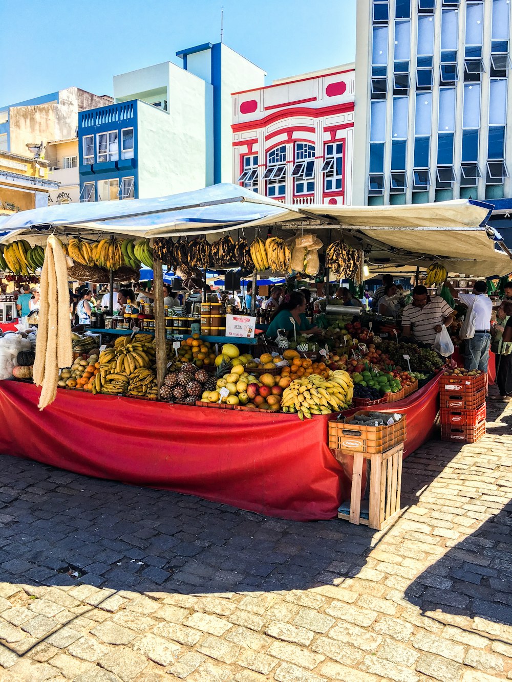 a fruit stand with a red cloth covering it