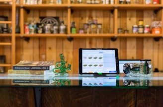 a tablet computer sitting on top of a glass table