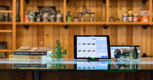 a tablet computer sitting on top of a glass table