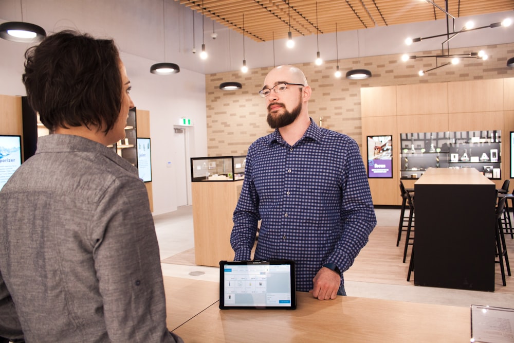 a man standing in front of a laptop computer