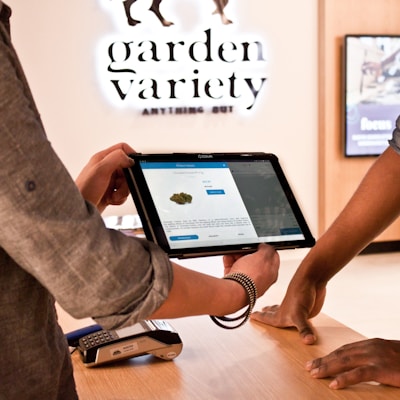 a man holding a tablet while standing next to another man