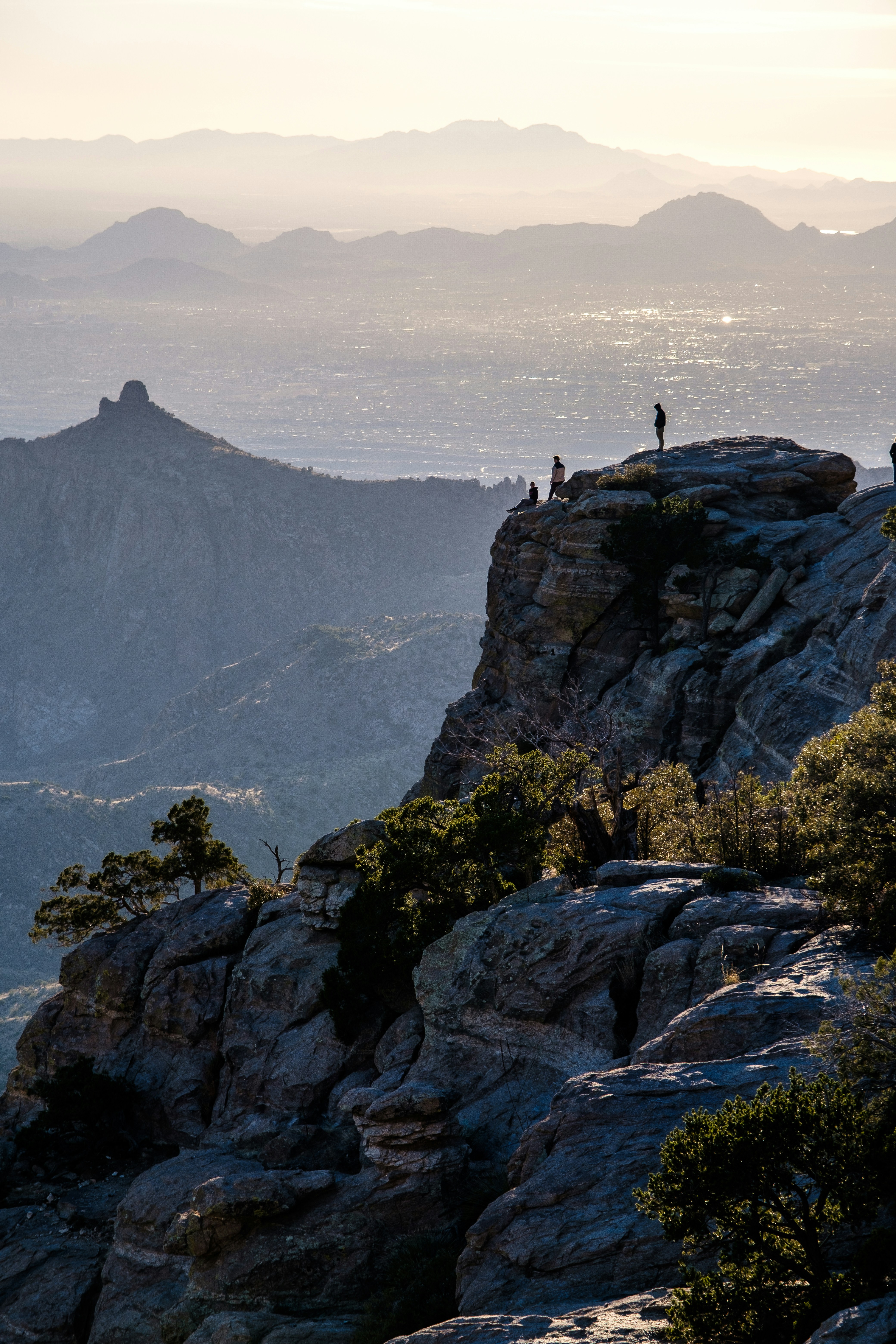 a couple of people standing on top of a mountain