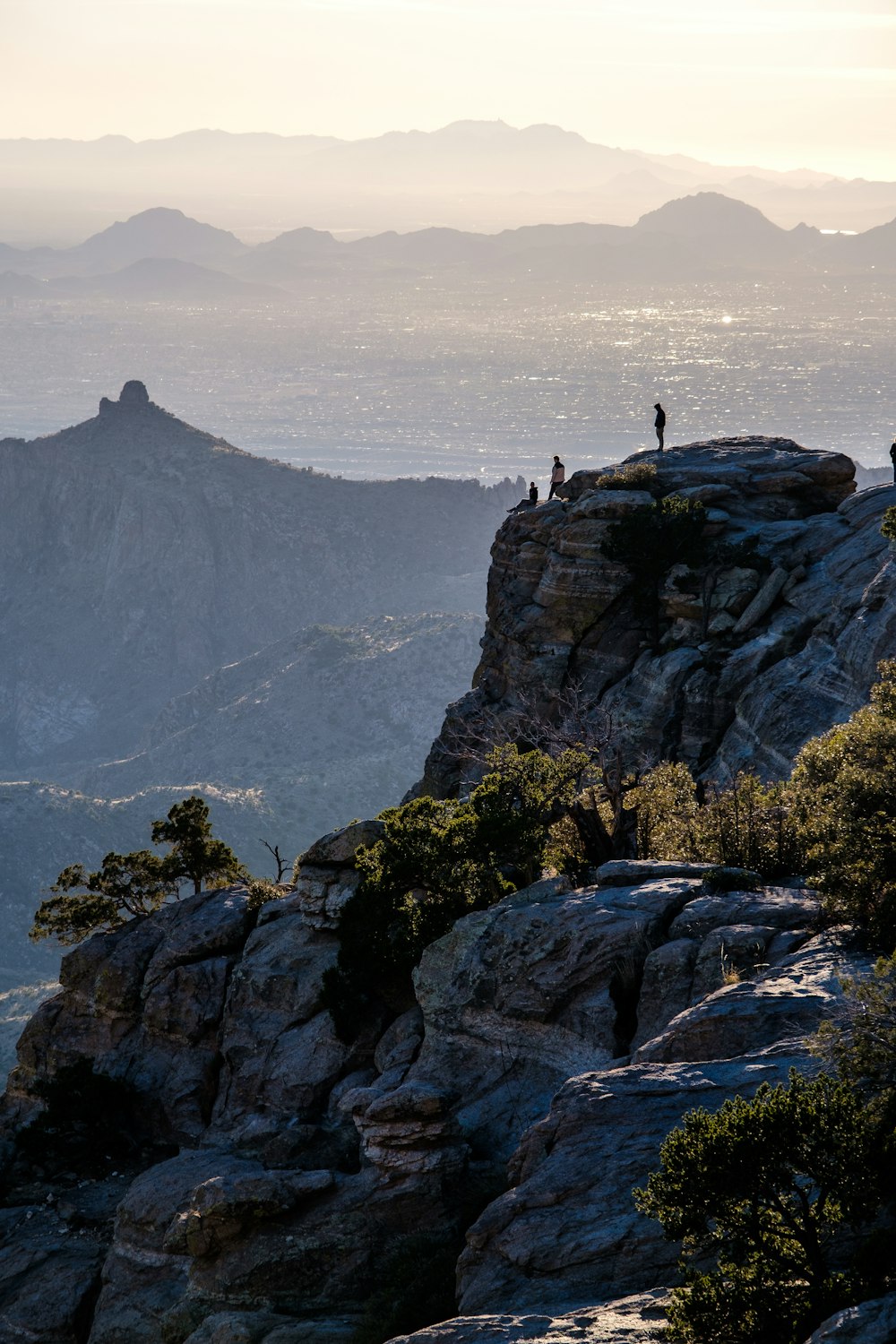 a couple of people standing on top of a mountain