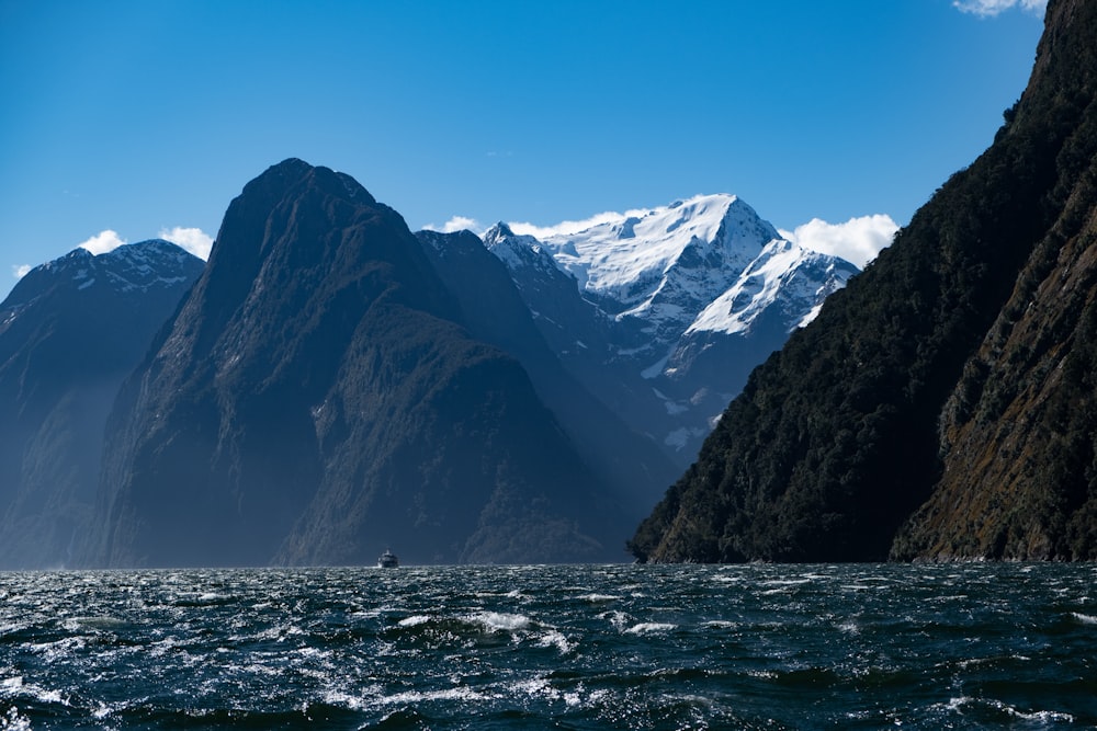 a large mountain range towering over a body of water