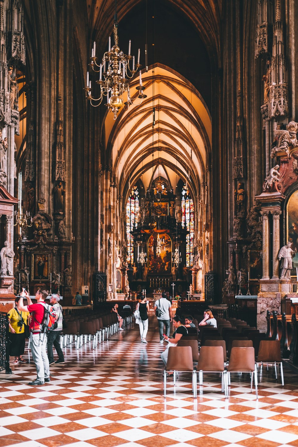 a large cathedral with a checkered floor and chandelier