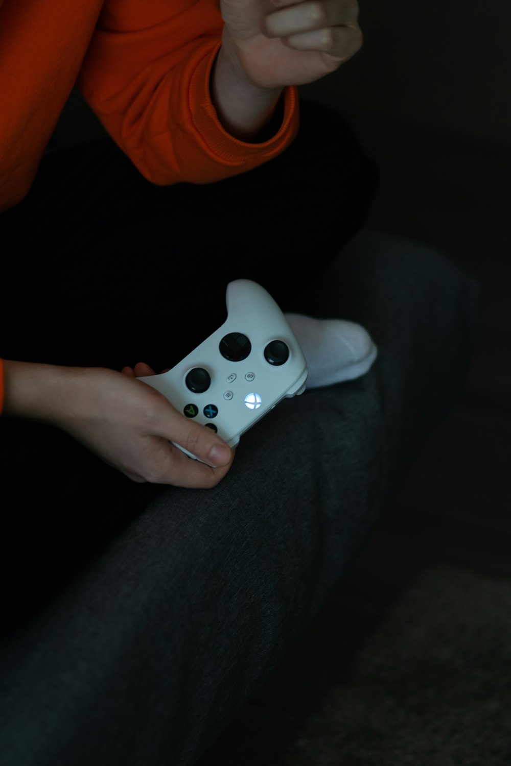 a person holding a white controller in their hand