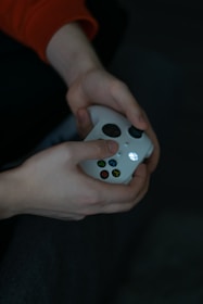 a close up of a person holding a remote control