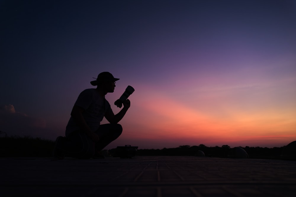 a man kneeling down while holding a baseball bat