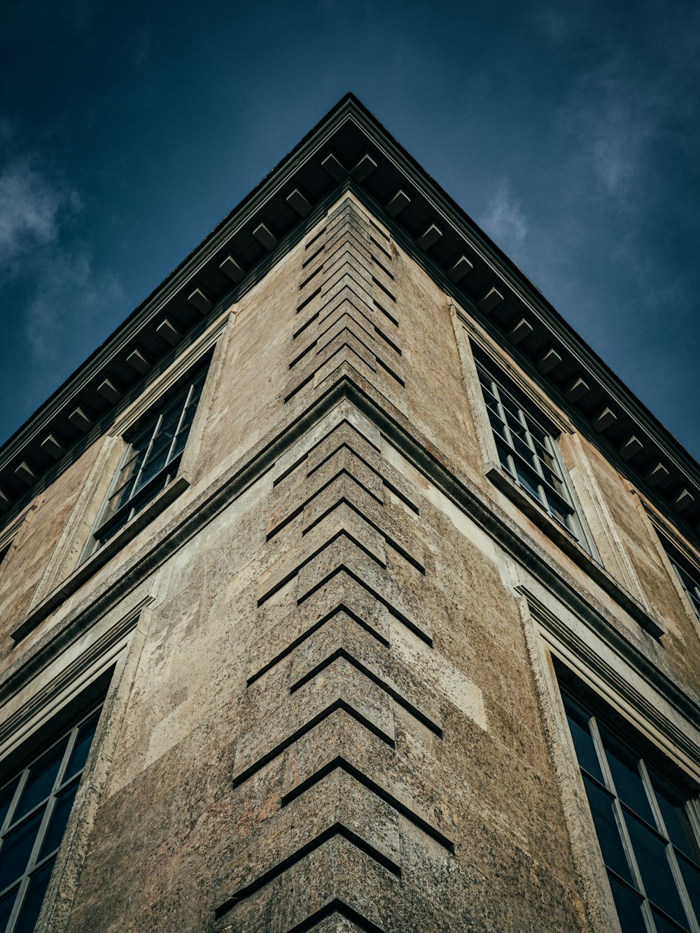 a tall brick building with a sky background