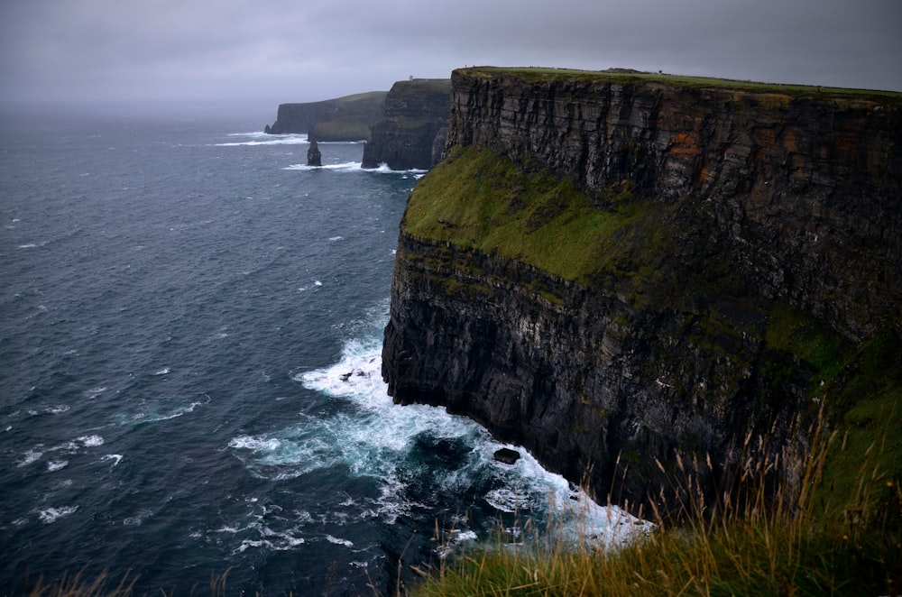 a cliff that is next to a body of water