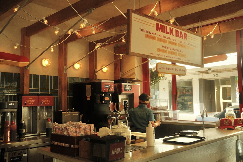 a man standing at a counter in a restaurant