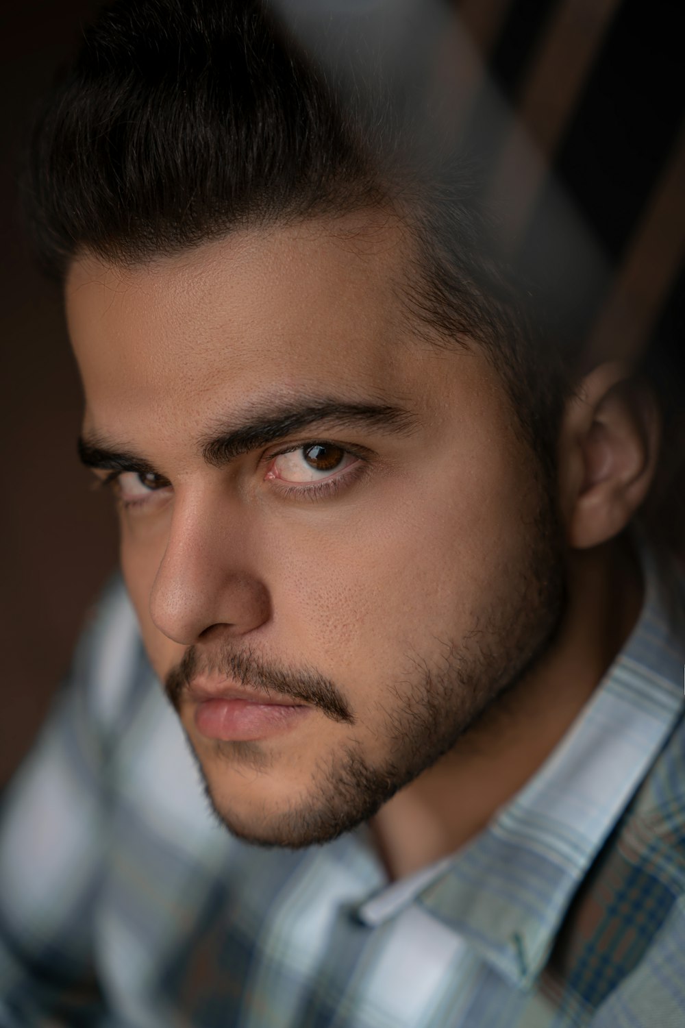 a close up of a person wearing a shirt and tie