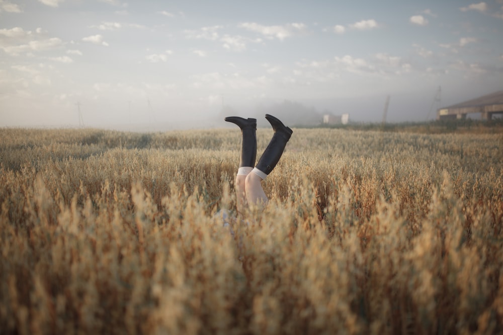 a person laying on their back in a field