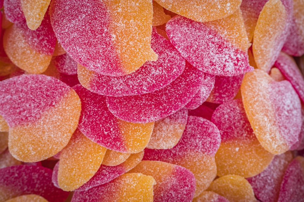 a pile of pink and yellow candy hearts