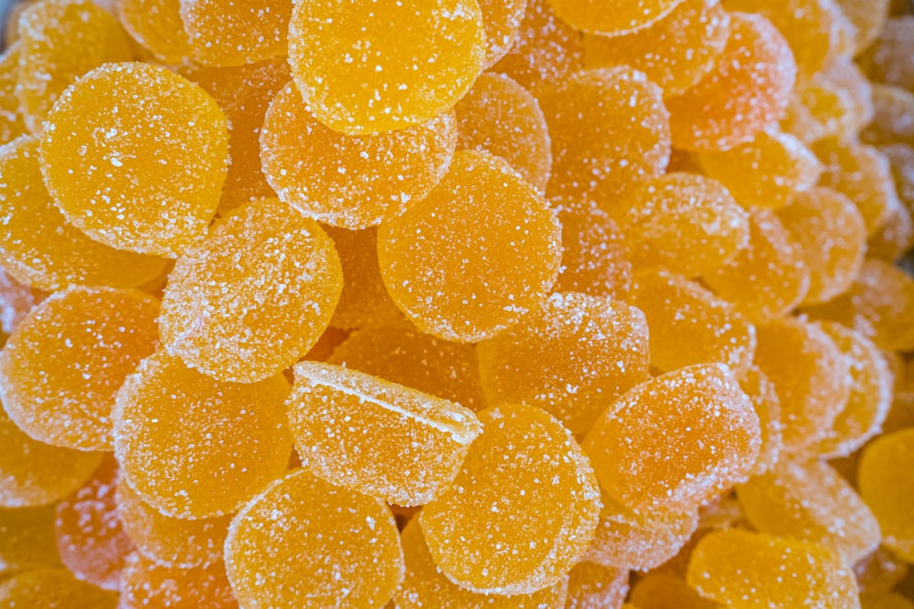 a close up of a bunch of yellow candies