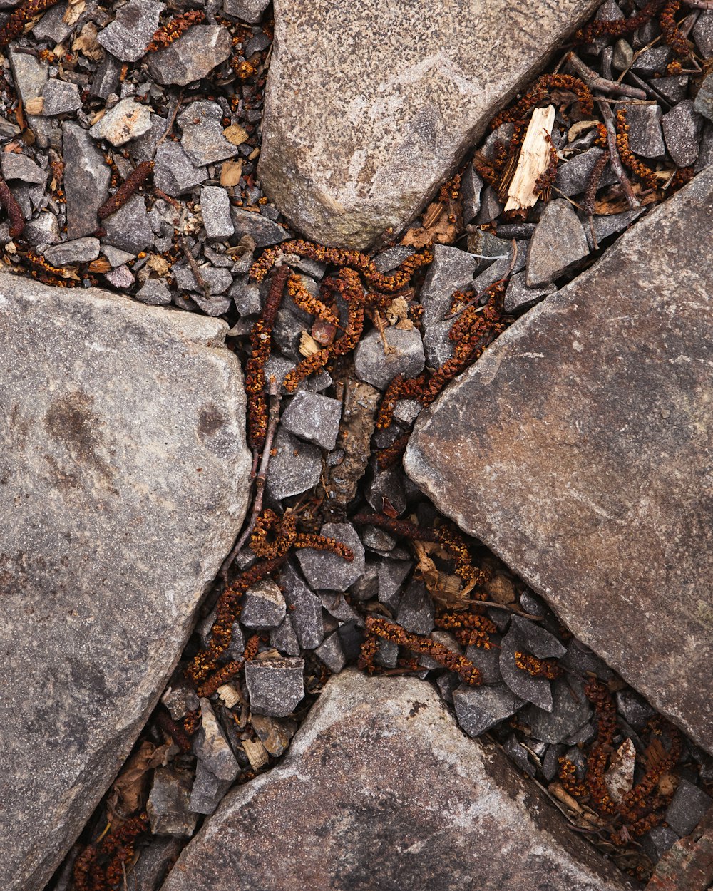 a cross made out of rocks on the ground