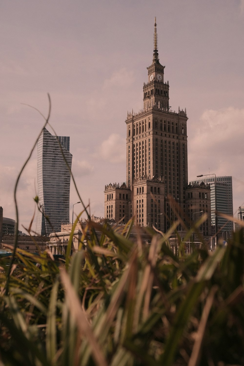 a tall building with a clock tower in the background