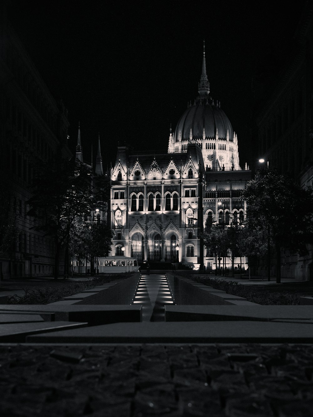 a building lit up at night with steps leading up to it