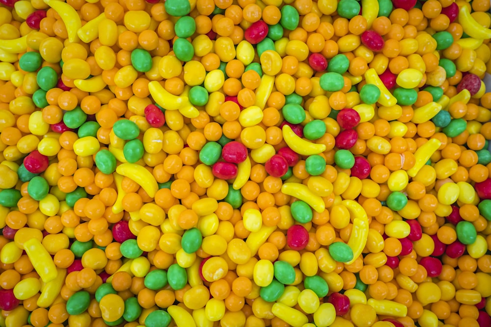 a large pile of yellow and green candies