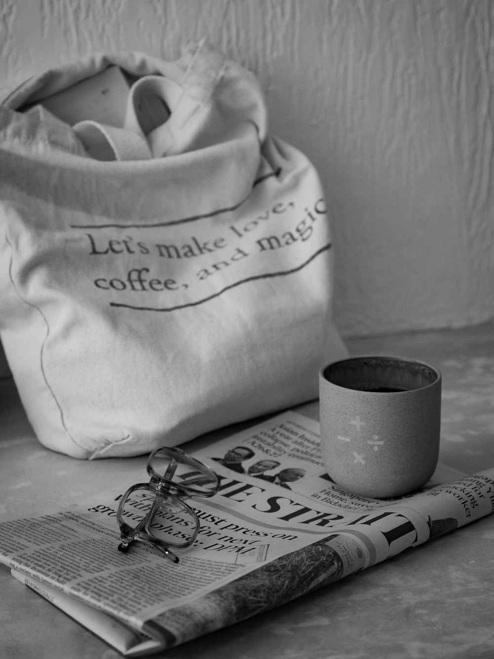 a newspaper and a cup on a table