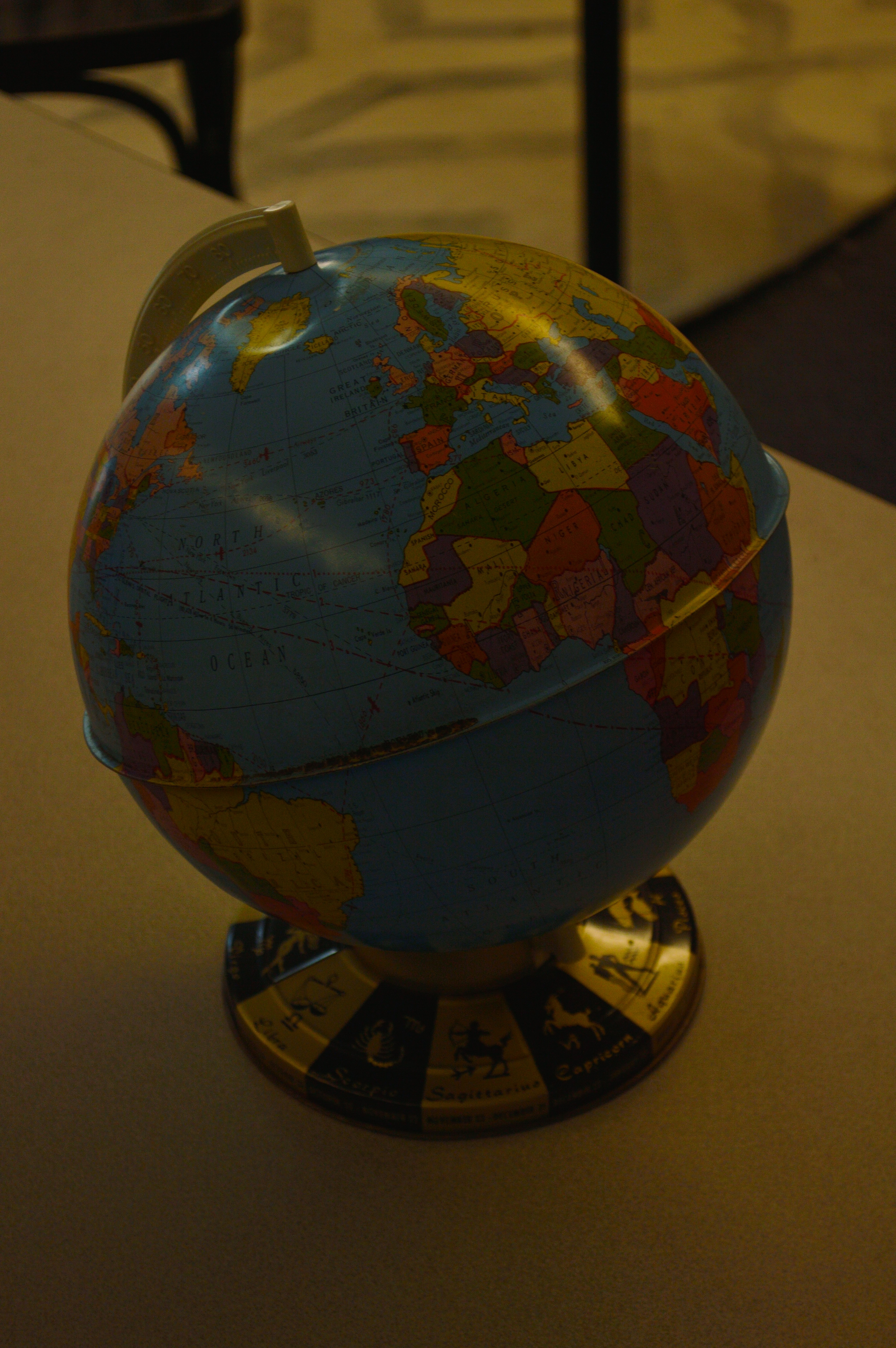 a blue and yellow globe sitting on top of a table