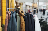 a rack of clothes hanging on a rail