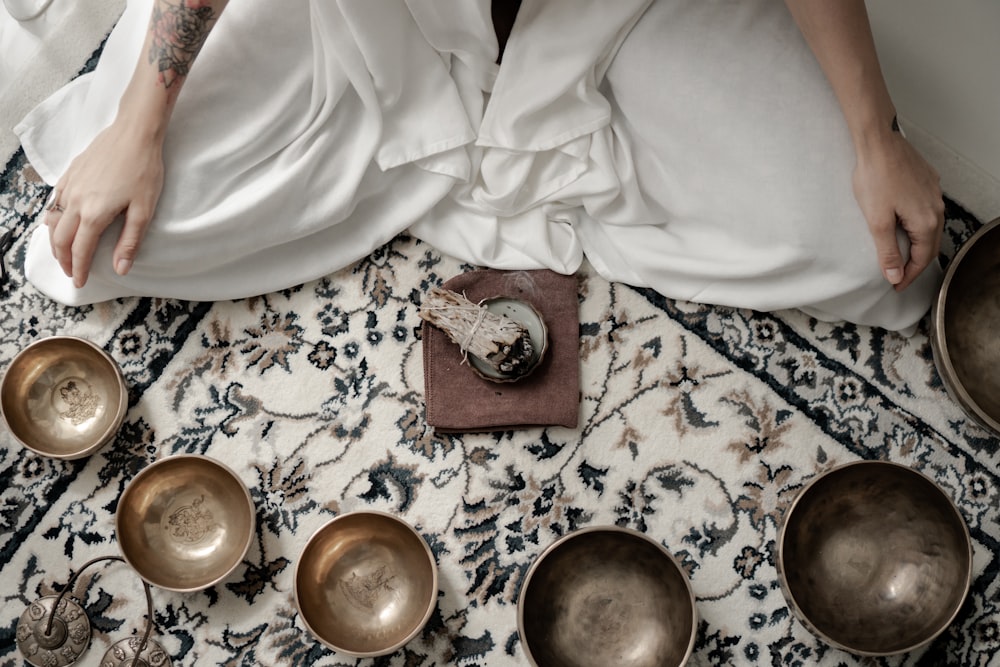 a person sitting at a table with plates of food