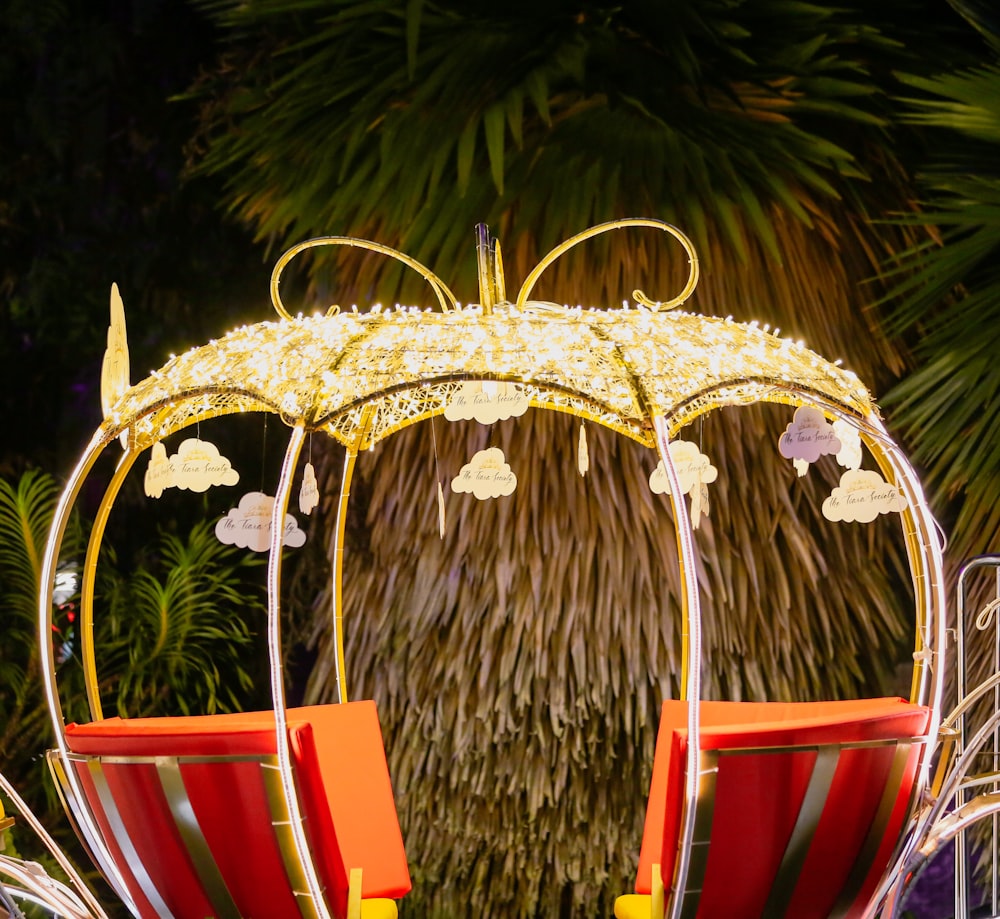 a yellow and red chair sitting under a yellow umbrella