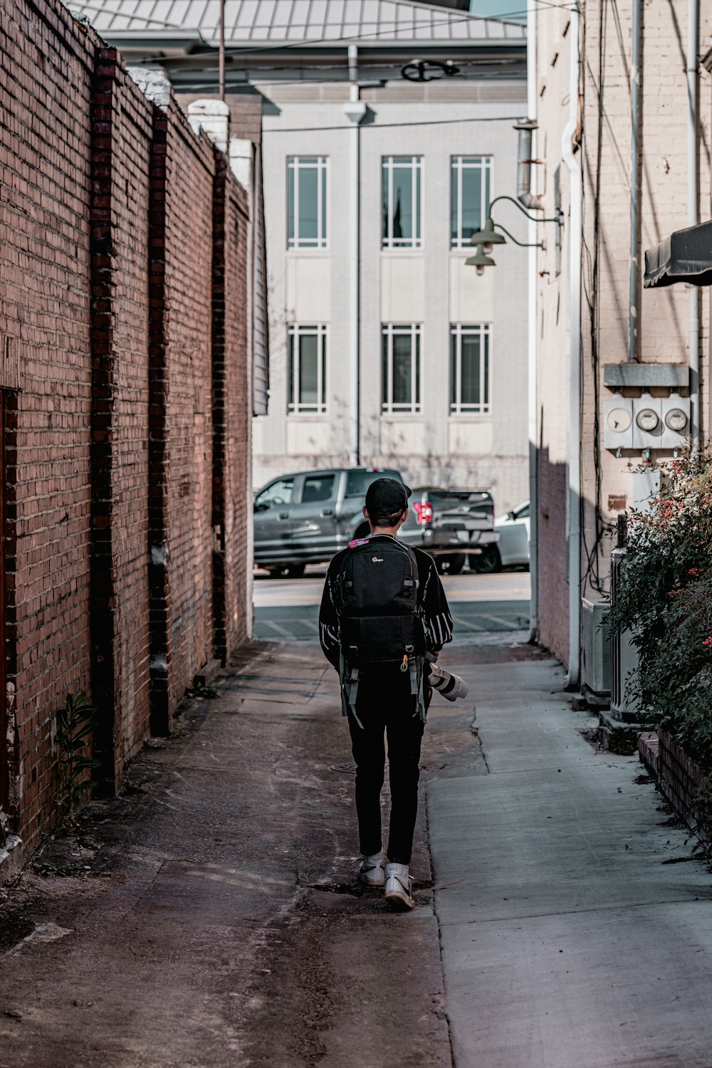 a person walking down a narrow alley way