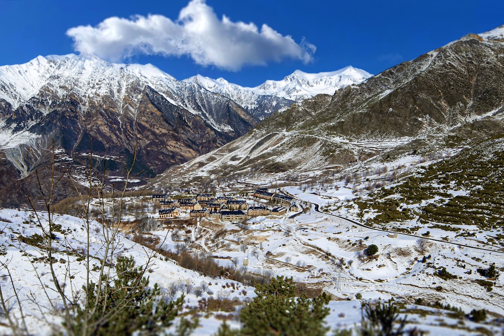 a snow covered mountain with a village in the distance