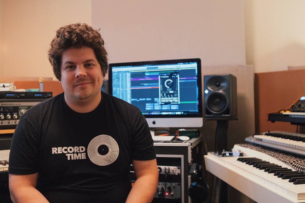 a man sitting in front of a recording equipment