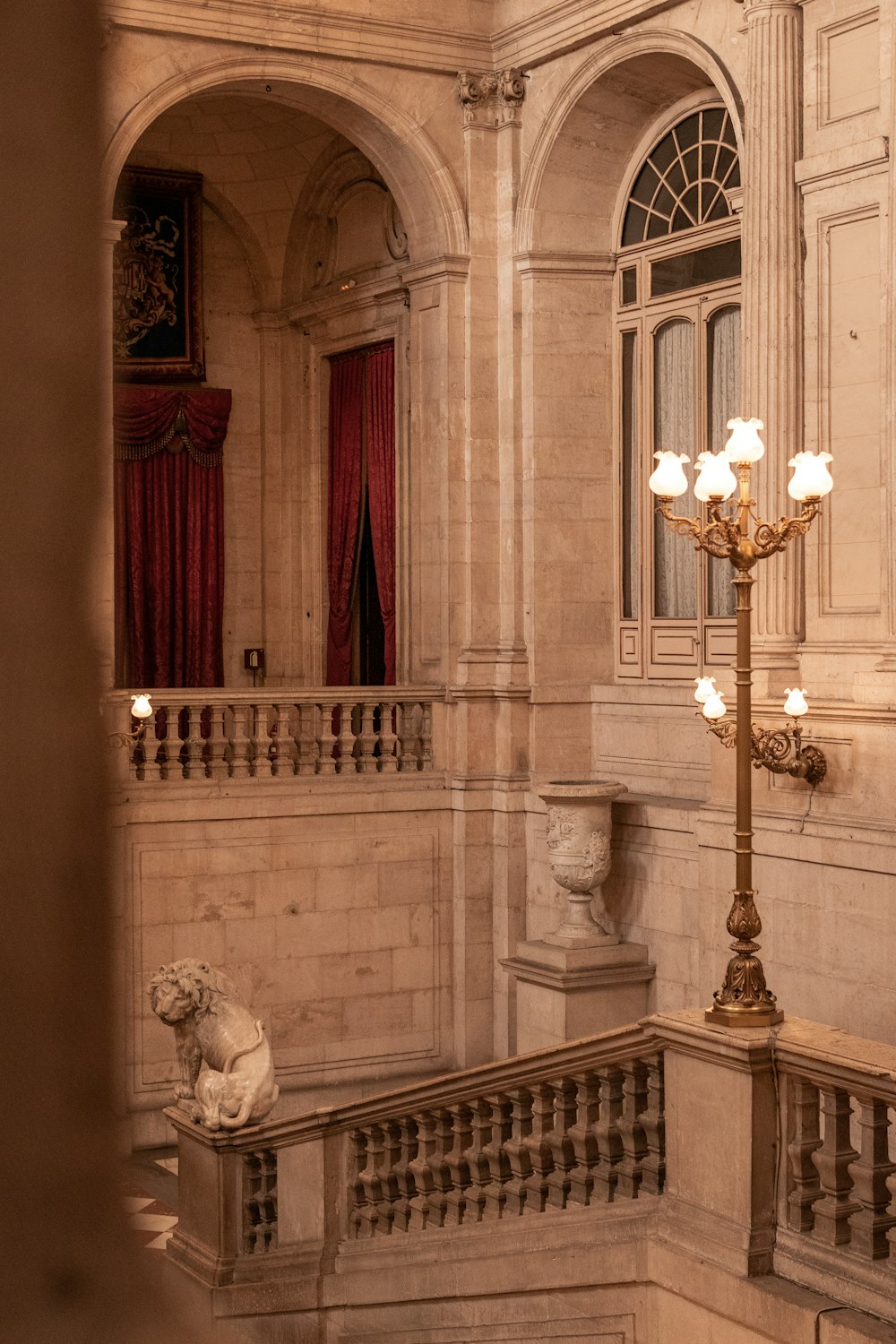 a view of a balcony with a chandelier and a statue