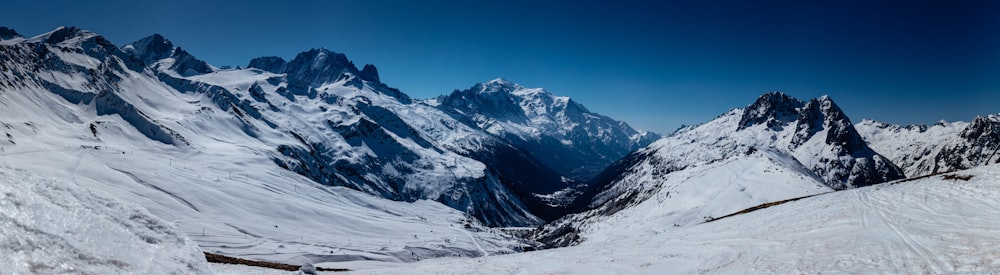 a snow covered mountain range with a sky background