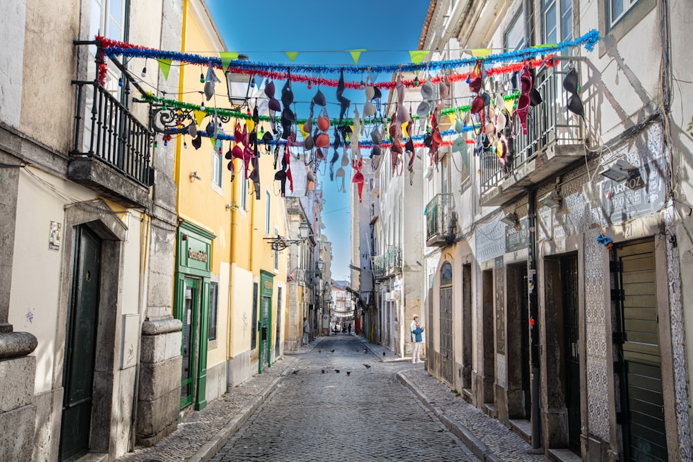 a narrow street with a bunch of clothes hanging over it