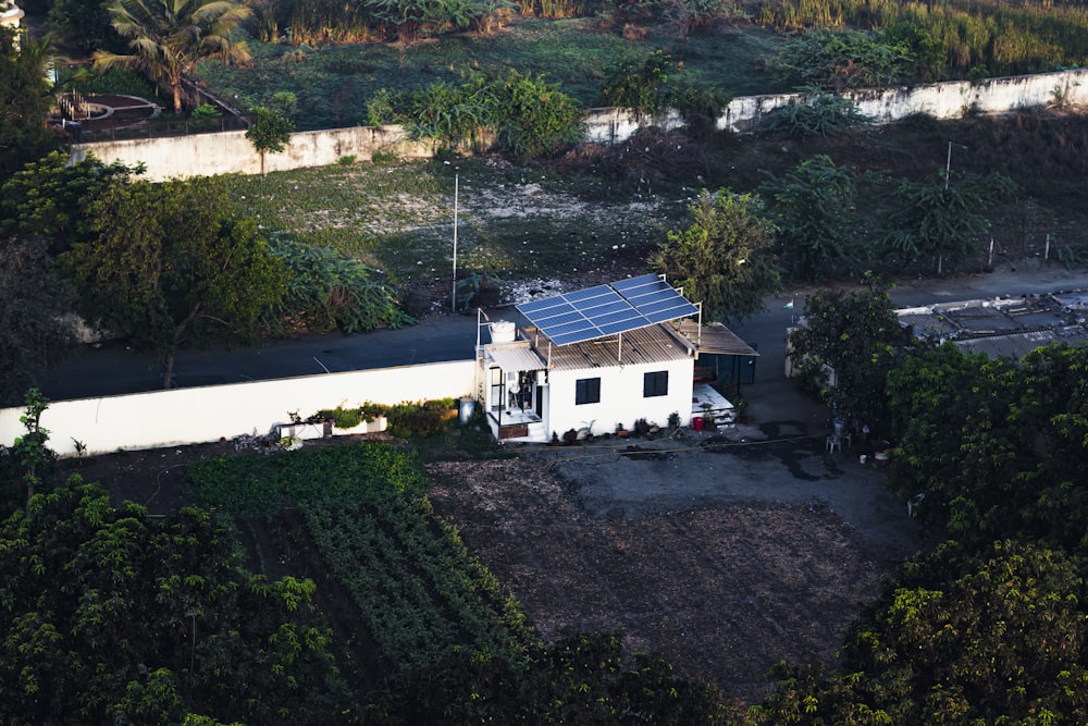 an aerial view of a house with a solar panel on the roof