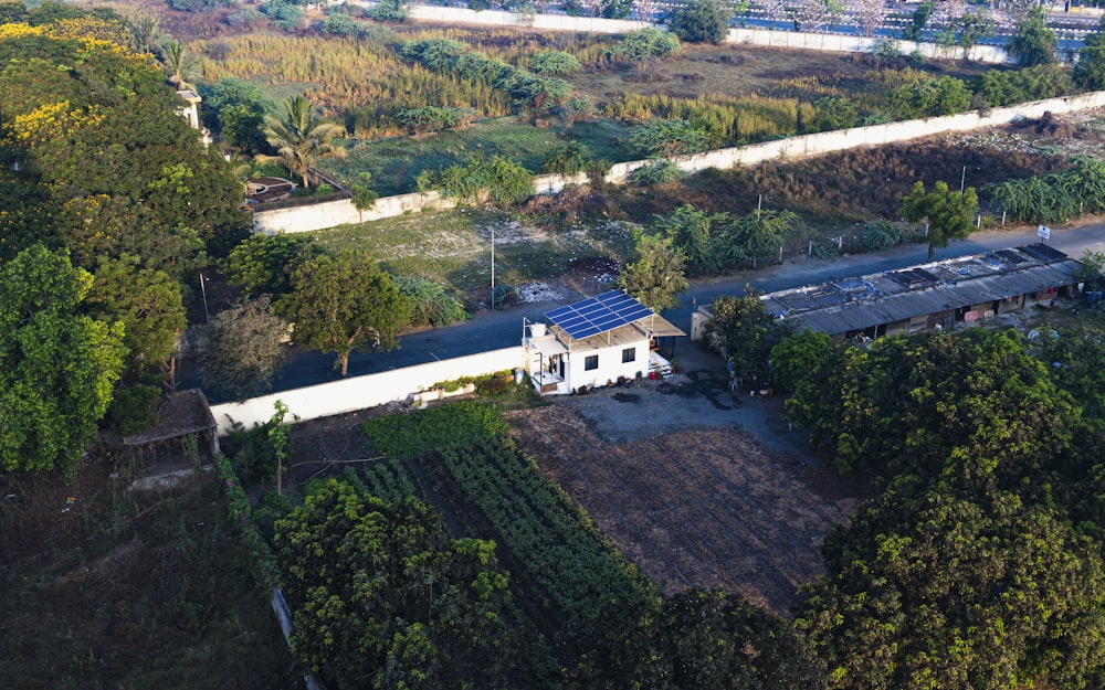 an aerial view of a house with a solar panel on the roof