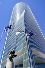 a tall building with a statue in front of it