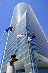 a tall building with a statue in front of it