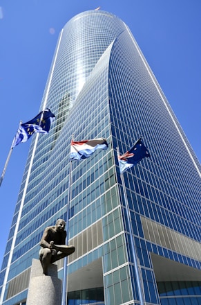 a tall building with a statue in front of it
