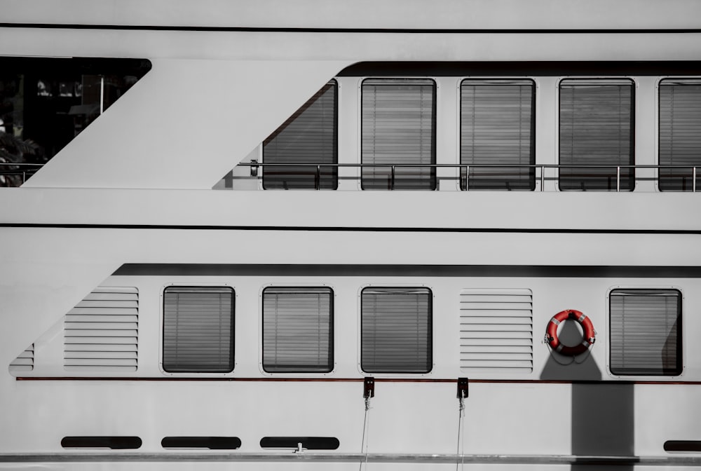 a large white boat with a red life preserver on it's side