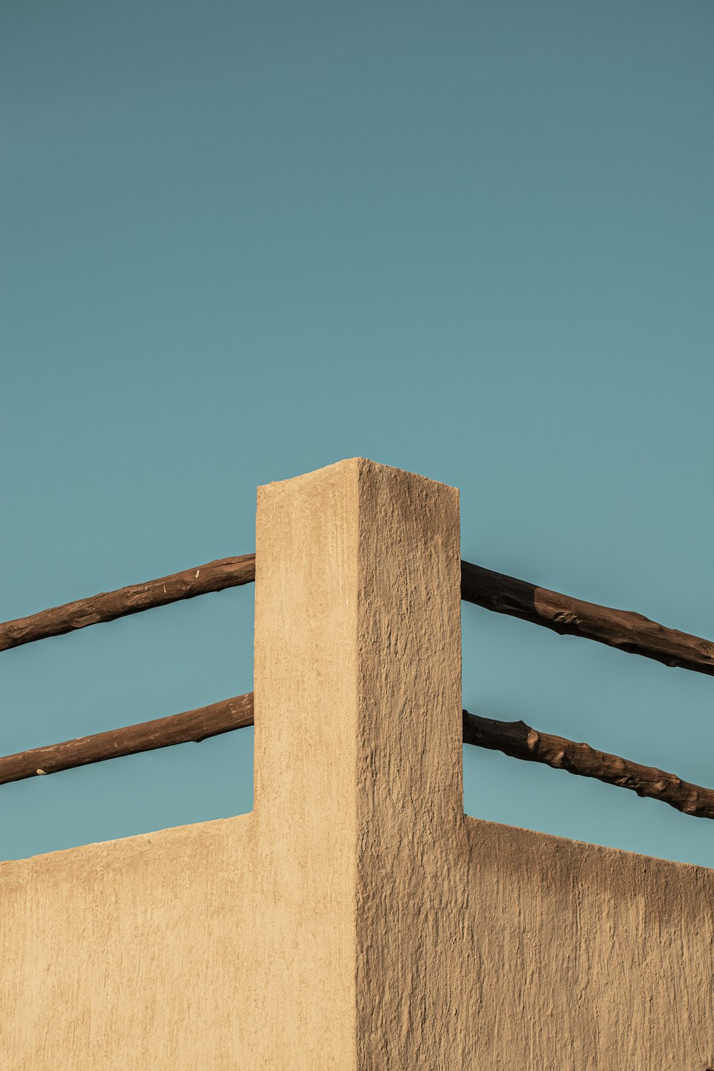 a bird perched on top of a wooden fence